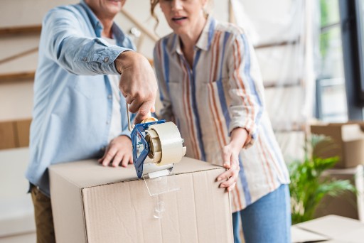 two seniors packing up to downsize to a one bedroom senior apartment