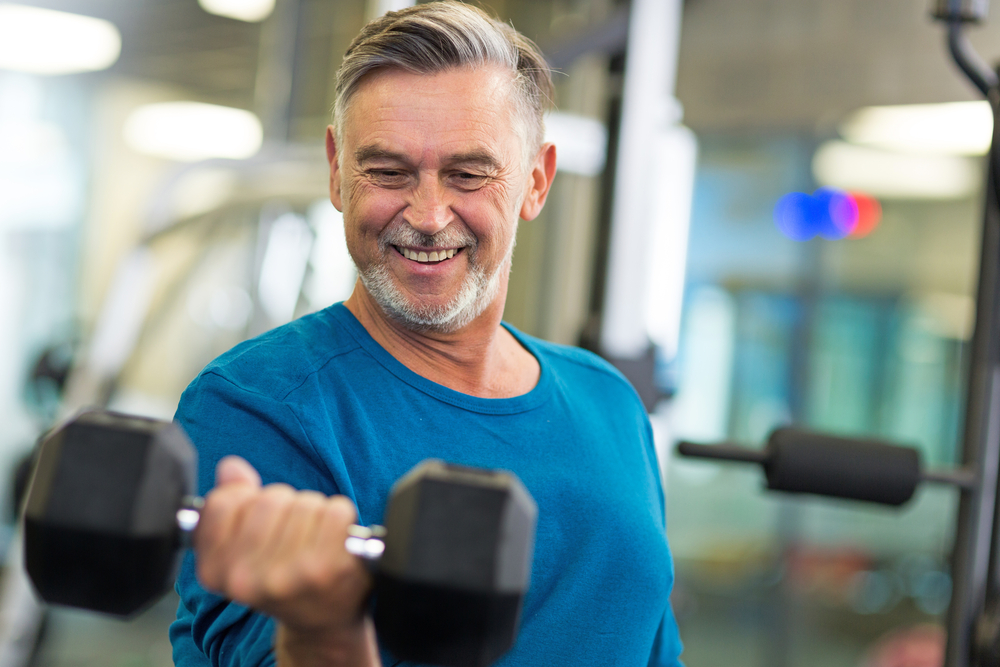 Senior man lifting weights