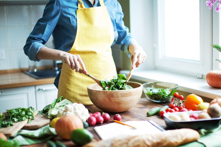 Woman preparing a salad with fresh vegetables